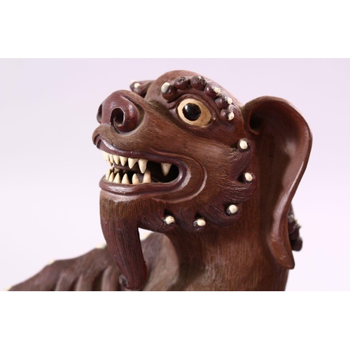 201 - A GOOD PAIR OF CHINESE 19TH CENTURY TERRACOTTA FORMED LION DOG FIGURES, the mirrored pair with glaze... 