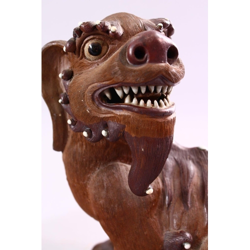 201 - A GOOD PAIR OF CHINESE 19TH CENTURY TERRACOTTA FORMED LION DOG FIGURES, the mirrored pair with glaze... 