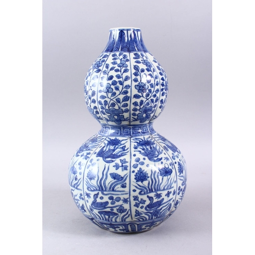 209 - A CHINESE MING STYLE BLUE & WHITE DOUBLE GOURD, with a ribbed section body, with scenes of phoenix a... 