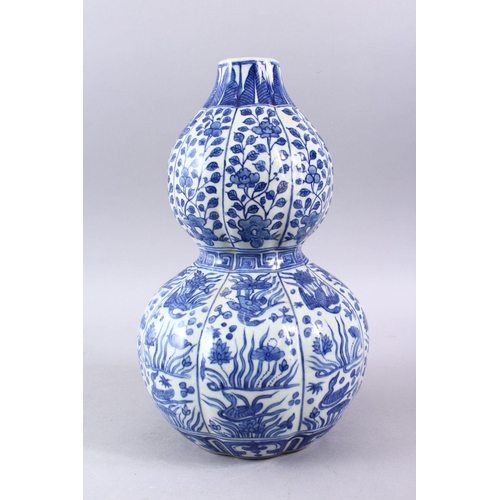 209 - A CHINESE MING STYLE BLUE & WHITE DOUBLE GOURD, with a ribbed section body, with scenes of phoenix a... 