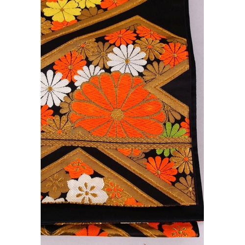 237 - A FINE QUALITY JAPANESE EMBROIDERED SILK FUKURO OBI TIE, with a black ground and floral and gilt emb... 