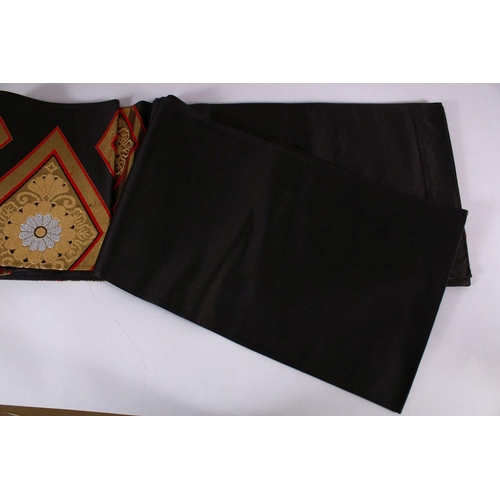 240 - A FINE JAPANESE SILK EMBROIDERED FUKURO OBI TIE - upon a black ground with silver and gold coloured ... 