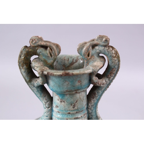 251 - A CHINESE TANG STYLE CELEDON GLAZED DOUBLE WALLED BOTTLE VASE, with dragon handles, 27cm.