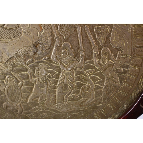 252 - A LARGE CHINESE CIRCULAR CAST BRONZE 'MIRROR' on a hardwood stand (stand AF), disc 46cm diameter.