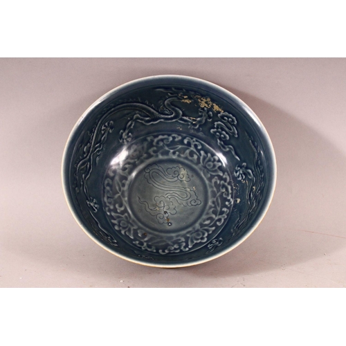 264 - A CHINESE MING STYLE DRAGON BOWL, with blue glazed interior and moulded dragon decoration, 20cm diam... 