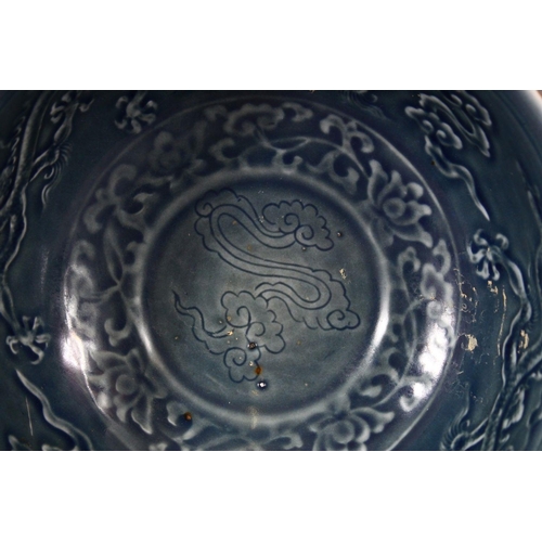 264 - A CHINESE MING STYLE DRAGON BOWL, with blue glazed interior and moulded dragon decoration, 20cm diam... 