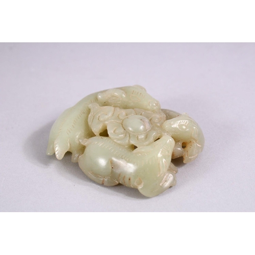 275 - A SMALL CHINESE CARVED JADE GROUP of three rams, in a fitted box.