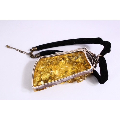 278 - A DECORATIVE PRESSED AMBER AND WHITE METAL MOUNTED NECKLACE.