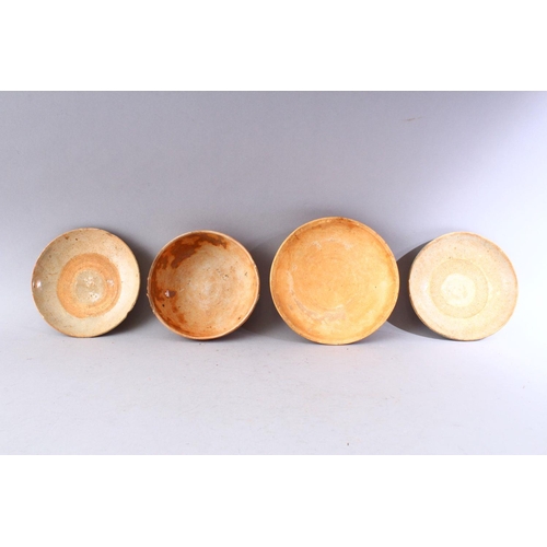 282 - A GROUP OF FOUR EARLY CHINESE EARTHENWARE CIRCULAR BOWLS, various sizes.