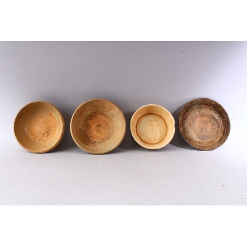 284 - A GROUP OF FOUR EARLY CHINESE EARTHENWARE CIRCULAR BOWLS, various sizes.