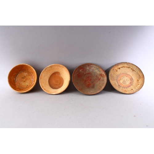 285 - A GROUP OF FOUR EARLY CHINESE EARTHENWARE CIRCULAR BOWLS, various sizes.