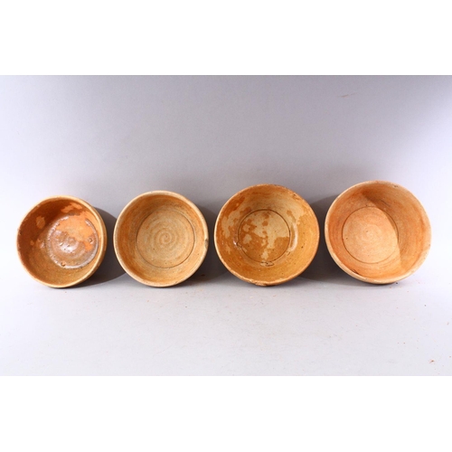 288 - A GROUP OF FOUR EARLY CHINESE EARTHENWARE CIRCULAR BOWLS, various sizes.