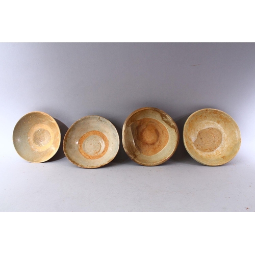 290 - A GROUP OF FOUR EARLY CHINESE EARTHENWARE CIRCULAR BOWLS, various sizes.