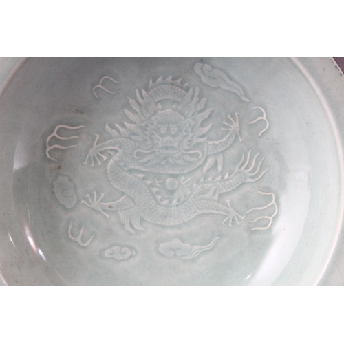 293 - A 20TH CENTURY CHINESE CELEDON CIRCULAR DISH, the centre with moulded dragon decoration, green groun... 