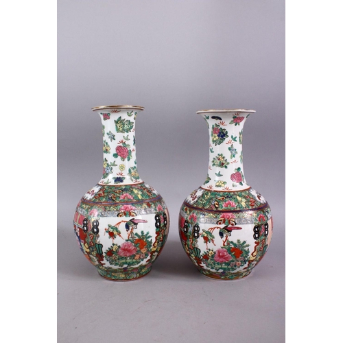 300 - A PAIR OF 20TH CENTURY FAMILLE ROSE BALUSTER VASES, painted with figures in an interior, 30cm high.