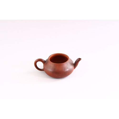 306 - A MINIATURE YIXING TEAPOT, 9cm wide.