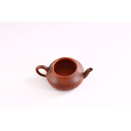 306 - A MINIATURE YIXING TEAPOT, 9cm wide.