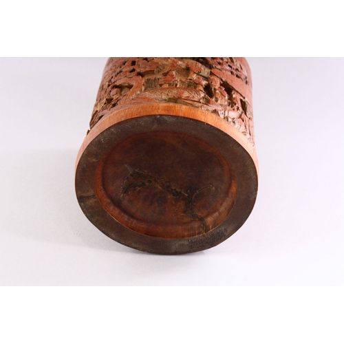 308 - A GOOD CHINESE BAMBOO BRUSH POT, deeply carved with figures in a mountainous landscape, 18cm high.