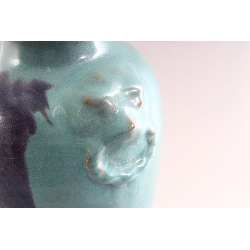 309 - A CHINESE PURPLE SPLASH POTTERY VASE, with moulded lion mask handles, 35cm high.