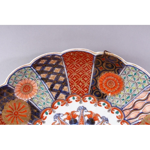 311 - A JAPANESE IMARI CHARGER, with shaped edge, painted with numerous geometric panels and chrysanthemum... 