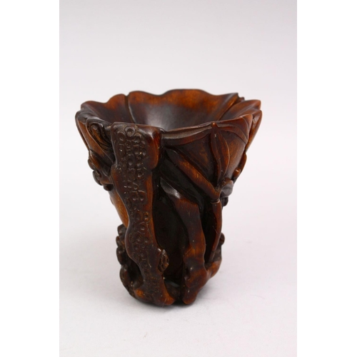 314 - A GOOD LATE 19TH CENTURY CARVED RHINO HORN LIBATION CUP, the body with prunus and blossom, 12cm high... 