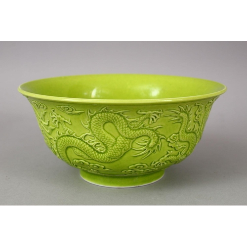 321 - A CHINESE GREEN GLAZED PORCELAIN DRAGON BOWL, with moulded decoration of dragons amongst stylized cl... 