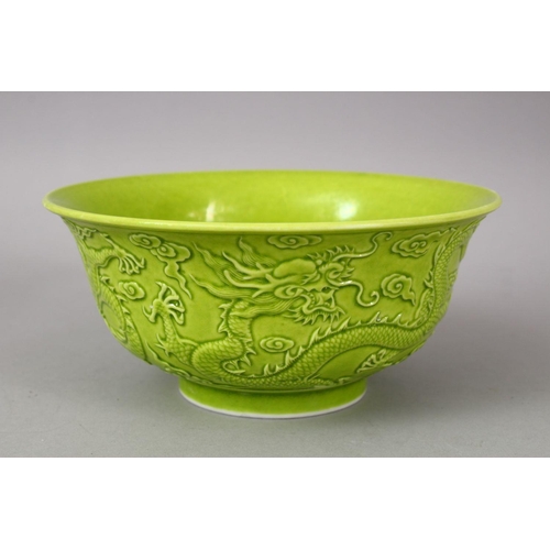 321 - A CHINESE GREEN GLAZED PORCELAIN DRAGON BOWL, with moulded decoration of dragons amongst stylized cl... 