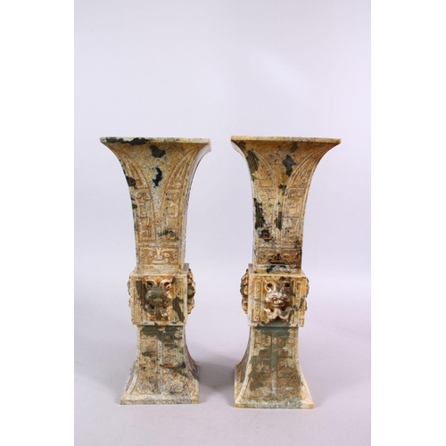 33 - A PAIR OF 19TH / 20TH CENTURY CHINESE ARCHAIC STYLE CARVED JADE VASES, each vase with a central sect... 