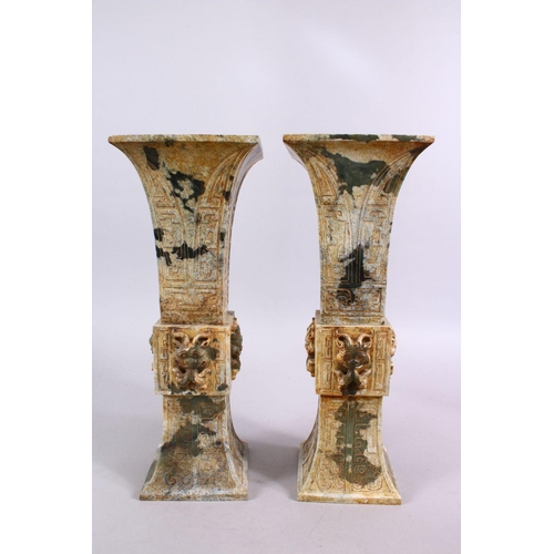 33 - A PAIR OF 19TH / 20TH CENTURY CHINESE ARCHAIC STYLE CARVED JADE VASES, each vase with a central sect... 