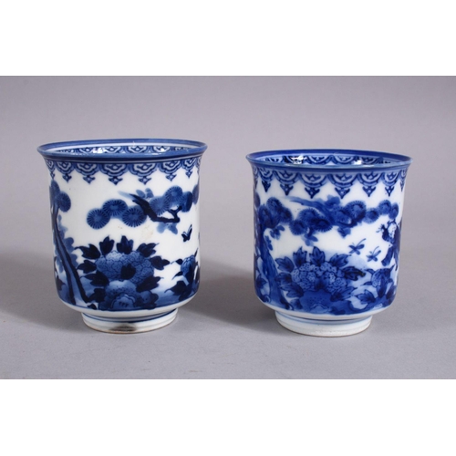 340 - A PAIR OF JAPANESE MEIJI PERIOD BLUE & WHITE PORCELAIN CUPS, each decorated with boys in landscaped ... 