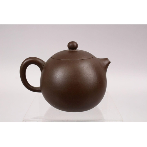 341 - A GOOD CHINESE YIXING CLAY TEAPOT, with carved symbol, base with impressed mark, 10cm wide.