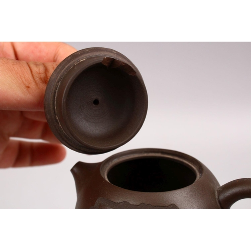 341 - A GOOD CHINESE YIXING CLAY TEAPOT, with carved symbol, base with impressed mark, 10cm wide.