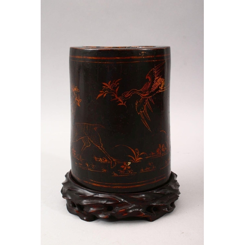 348 - A GOOD 19TH CENTURY CHINESE LACQUER BRUSH POT & STAND, The pot decorated with gold lacquer to depict... 