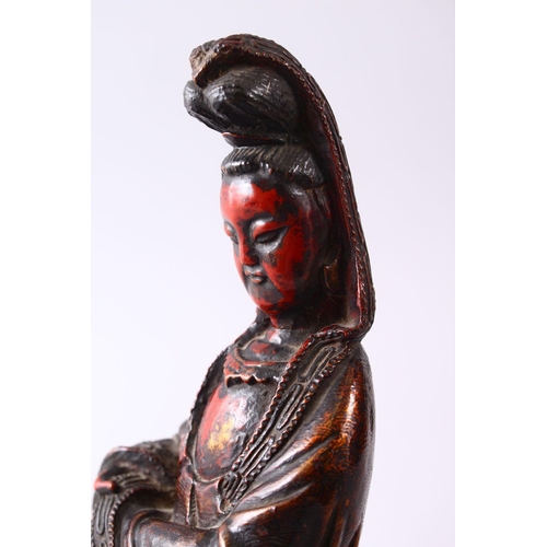 349 - A 19TH CENTURY CHINESE CARVED WOOD & LACQUER FIGURE OF GUANYIN, in a seated position, with carved wa... 