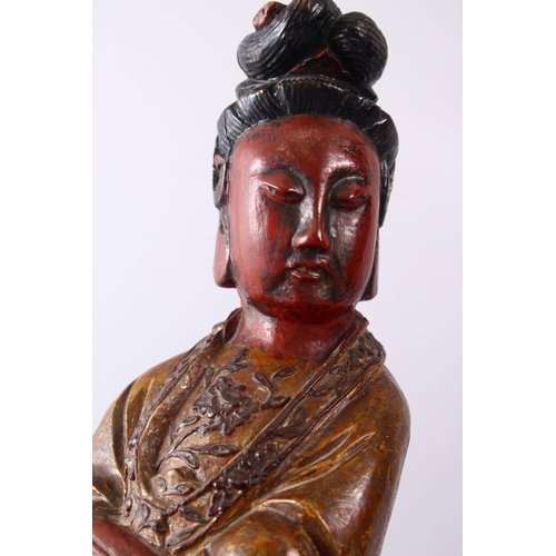 35 - A LARGE 19TH CENTURY CHINESE CARVED AND LACQUERED WOODEN FIGURE OF GUANYIN, with carved wave decorat... 