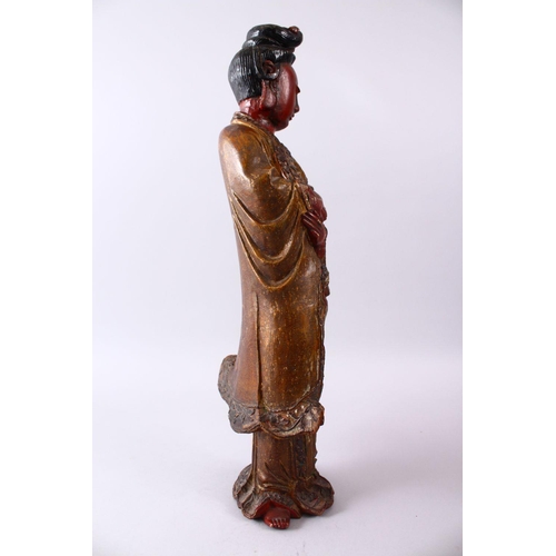 35 - A LARGE 19TH CENTURY CHINESE CARVED AND LACQUERED WOODEN FIGURE OF GUANYIN, with carved wave decorat... 