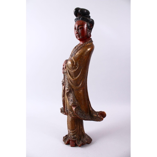 35 - A LARGE 19TH CENTURY CHINESE CARVED AND LACQUERED WOODEN FIGURE OF GUANYIN, with carved wave decorat... 