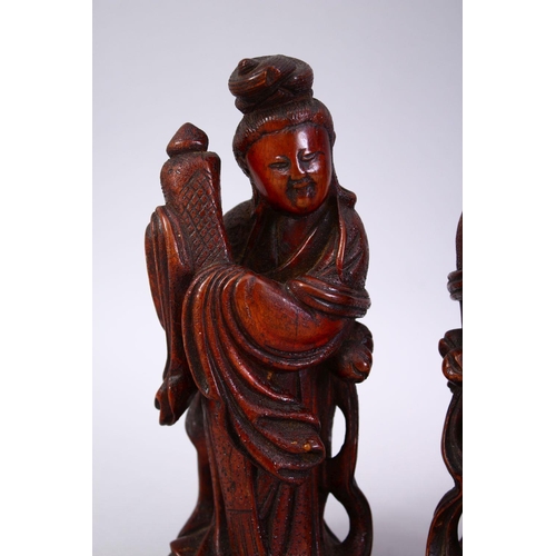 356 - A PAIR OF CHINESE 19TH CENTURY CARVED WOODEN FIGURES, 22cm high