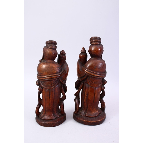 356 - A PAIR OF CHINESE 19TH CENTURY CARVED WOODEN FIGURES, 22cm high