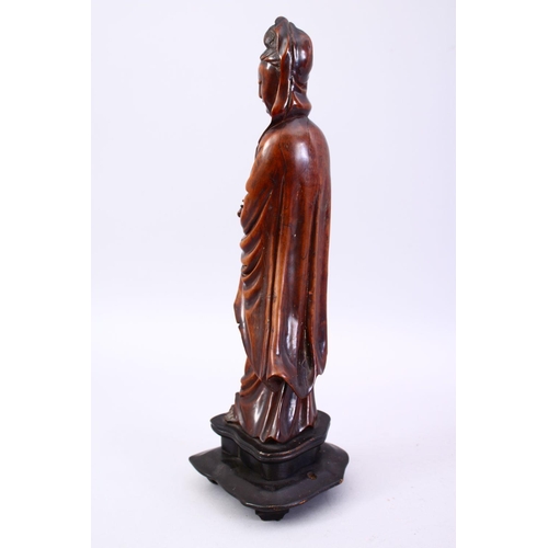 36 - A GOOD JAPANESE MEIJI PERIOD CARVED WOOD OKIMONO OF KWANNON, stood holding a scroll, fitted to a har... 