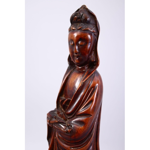 36 - A GOOD JAPANESE MEIJI PERIOD CARVED WOOD OKIMONO OF KWANNON, stood holding a scroll, fitted to a har... 