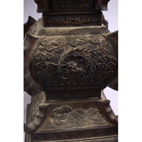 362 - A LARGE & HEAVY PAIR OF JAPANESE BRONZE RELIEF DRAGON VASES, carved in relief with dragons and waves... 