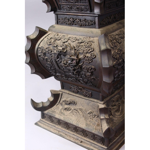 362 - A LARGE & HEAVY PAIR OF JAPANESE BRONZE RELIEF DRAGON VASES, carved in relief with dragons and waves... 