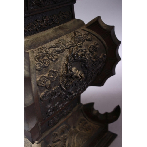 362 - A LARGE & HEAVY PAIR OF JAPANESE BRONZE RELIEF DRAGON VASES, carved in relief with dragons and waves... 