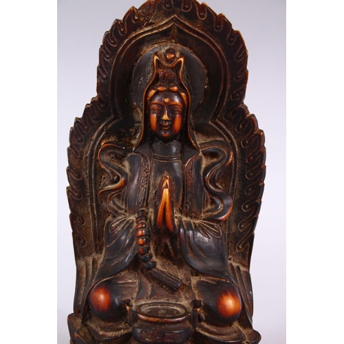 369 - A GOOD CHINESE CARVED IVORY STYLE FIGURE OF SEATED GUANYIN, seated upon a lotus base, with her hands... 