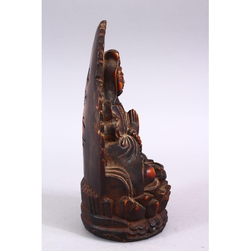 369 - A GOOD CHINESE CARVED IVORY STYLE FIGURE OF SEATED GUANYIN, seated upon a lotus base, with her hands... 