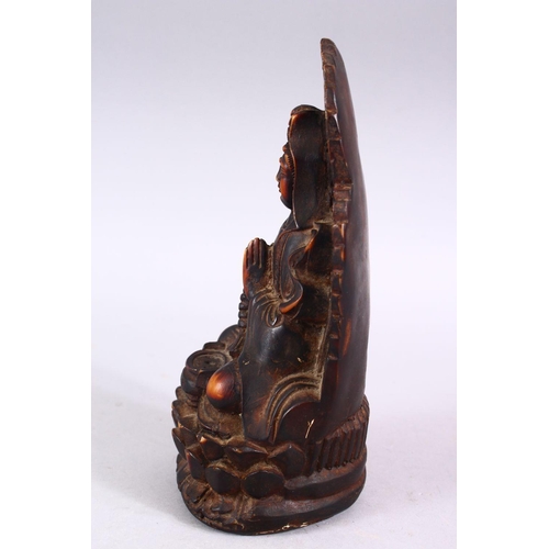 369 - A GOOD CHINESE CARVED IVORY STYLE FIGURE OF SEATED GUANYIN, seated upon a lotus base, with her hands... 