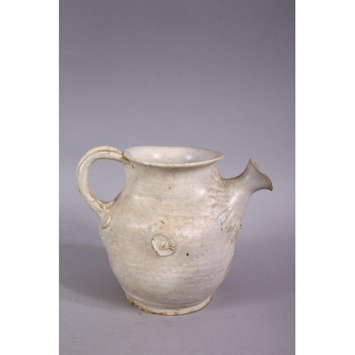 375 - AN EARLY CHINESE POTTERY JUG, with floral decoration, 11cm high.