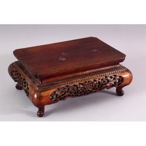 380 - A CHINESE PIERCED AND CARVED RECTANGULAR STAND and two other stands.