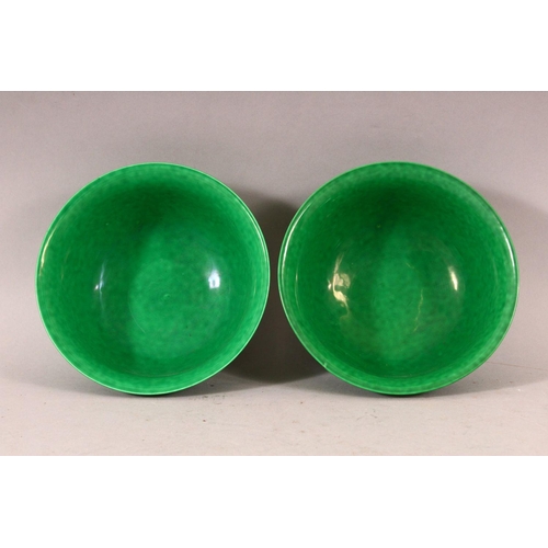 383 - A PAIR OF CHINESE GREEN GROUND MOULDED DRAGON BOWLS, 16cm diameter.